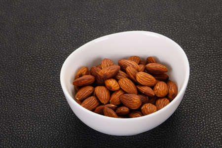 Almonds nuts heap in the bowlの写真素材