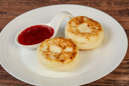 Cottage cheese pancakes with strawberry jam for breakfastの写真素材