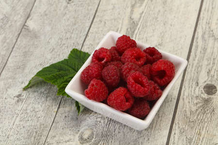 Red bright ripe sweet raspberry with leaf