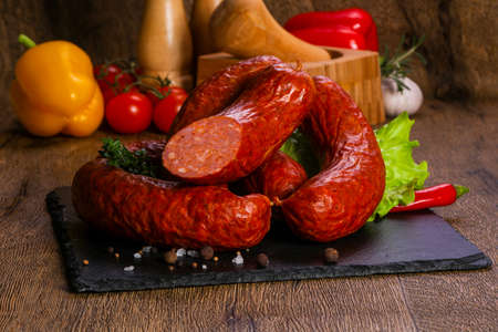Pork sausages over wooden background