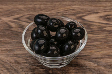 Marinated Black olives in the bowlの写真素材