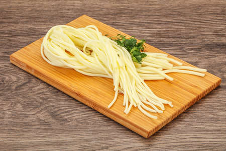 Chechil spaghetti cheese snack over board