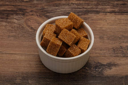 Brown cane sugar cubs in the bowlの写真素材