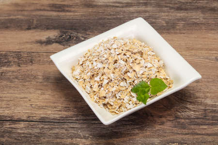 Raw oats in the bowl for breakfastの写真素材