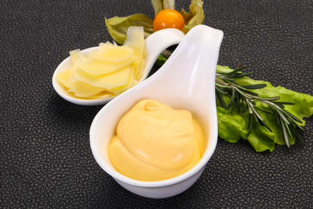 Cheese sauce in the bowl served sliced parmesanの写真素材