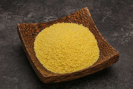 Raw cous cous heap in the bowl for cooking