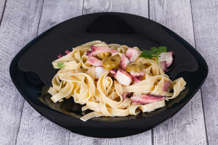 Pasta with octopus and olivesの写真素材