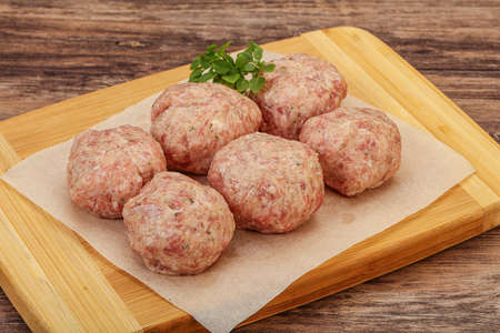 Dietary cuisine Raw turkey meatball for cookingの写真素材
