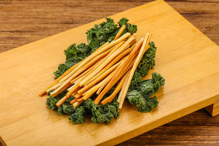 Caucasian Chechel cheese sticks over board