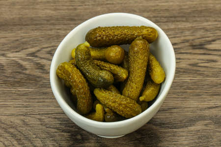 Pickled young gherkin in the bowlの写真素材