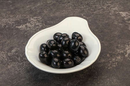 Marinated Black olives in the bowlの写真素材