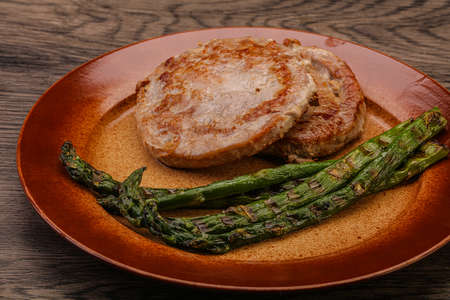 Grilled tuna steak with green asparagusの写真素材