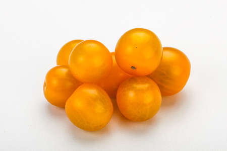 Fresh yellow tasty cherry tomato heapの写真素材