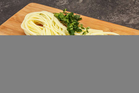 Chechil spaghetti cheese snack over board