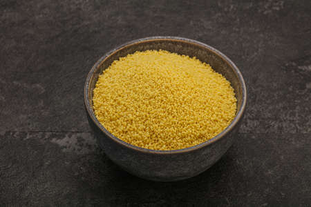 Raw cous cous heap in the bowl for cooking