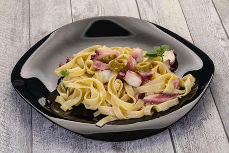 Pasta with octopus and olivesの写真素材