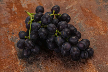 Fresh ripe sweet red grape on the branchの写真素材