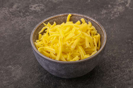 Shredded yellow cheese in the bowl for cooking