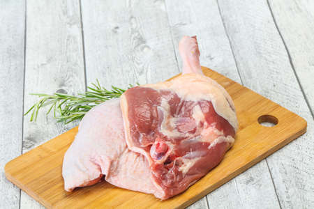 Raw duck leg served rosemary for cookingの写真素材