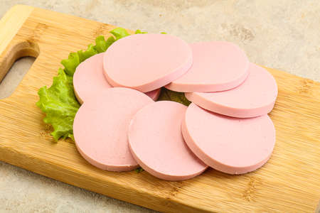 Sliced sausage snack served with salad leavesの写真素材