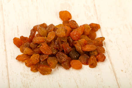 Raisin heap over the light wooden backgroundの写真素材