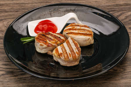 Grilled pork medallion with tomato sauce served rosemaryの写真素材