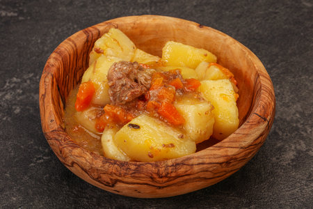 Roasted potato and beef with sauce and vegetablesの写真素材