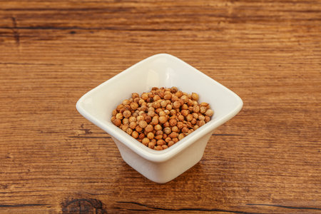 Dry Coriander seeds in the bowlの写真素材