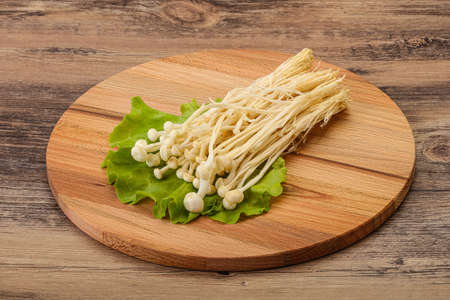 Raw Japanese Enoki mushrooms for cookingの写真素材