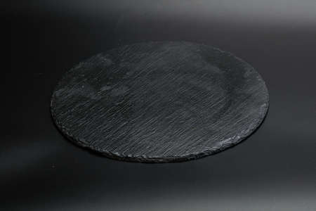 Black stone table plate for kitchen isolatedの写真素材