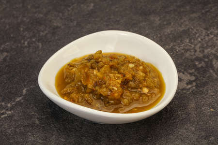 Green spicy sauce with pepper in the bowl