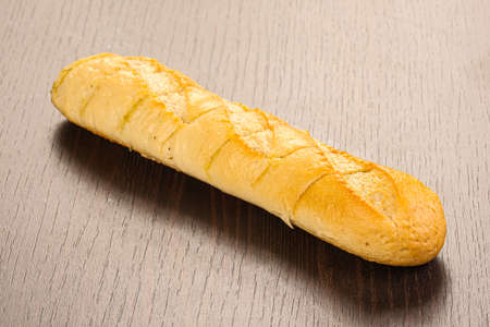 Crust tasty baguette over board isolatedの写真素材