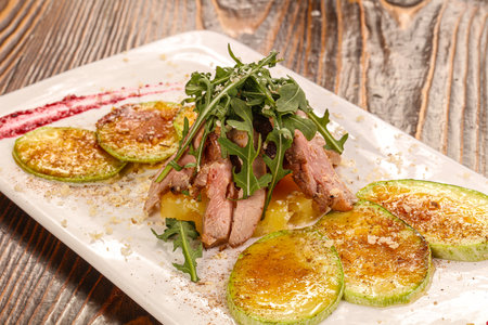 Baked Beef tongue with vegetables and sauceの写真素材