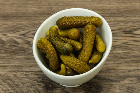 Pickled young gherkin in the bowlの写真素材