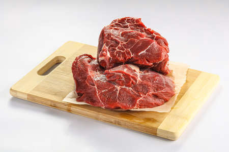 Raw beef neck over board isolated