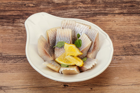Marinated Herring fillet with sliced lemonの写真素材