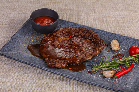 Grilled beef steak served pepper and rosemaryの写真素材