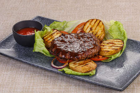 Grilled Beef cutlet with vegetables served onionの写真素材