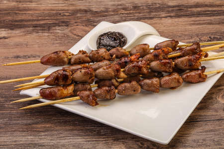 Asian cuisine - chicken hearts skewer with pepper sauceの写真素材