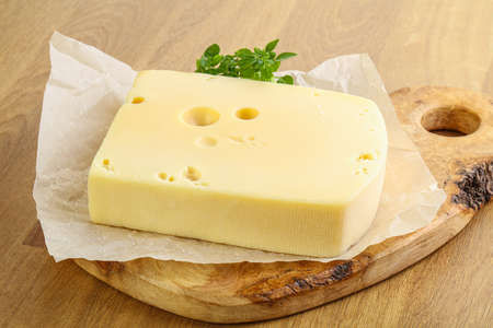 Maasdam cheese brick over the boardの写真素材