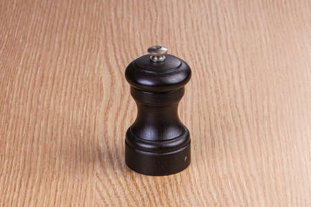 Wooden pepper mill for kitchen servingの写真素材