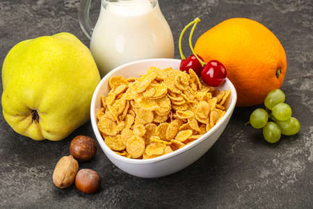 Breakfast with corn flakes, fruits and milkの写真素材