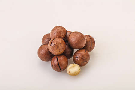 Brown closeup macadamia nut heap over background