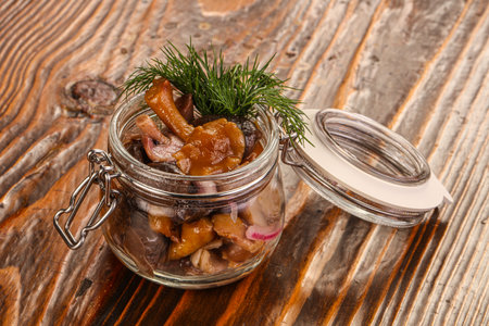 Pickled honey mushrooms in the glass with dillの写真素材