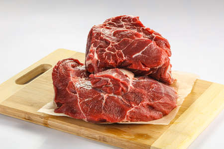 Raw beef neck over board isolated