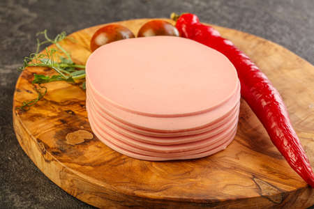 Sliced pork sausages stack over board for snack