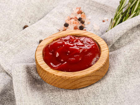Tasty tomato sauce in the wooden bowlの写真素材