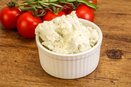 Soft cream cheese with herbs in the bowlの写真素材