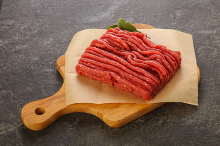 Raw beef minced meat over board for cooking