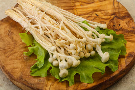 Raw Japanese Enoki mushrooms for cookingの写真素材